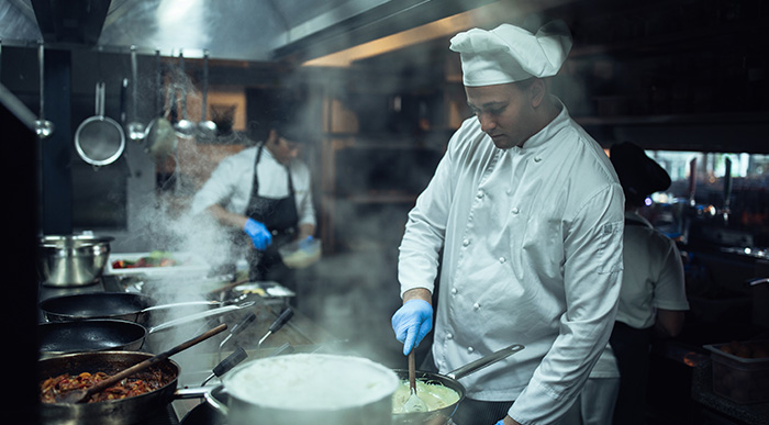 A chef cooking in a kitchen.