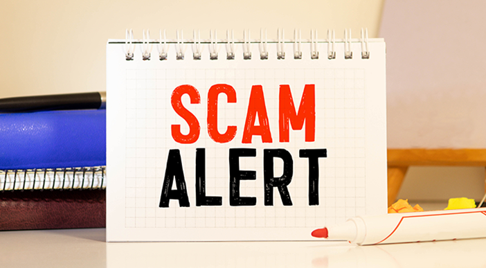 A sign that says Scam Alert.