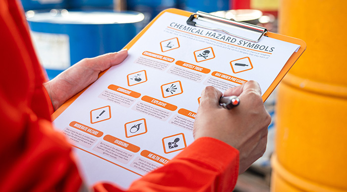 A person reviewing a hazard symbols worksheet.