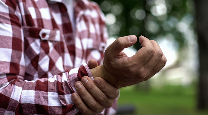 A worker holding his wrist.