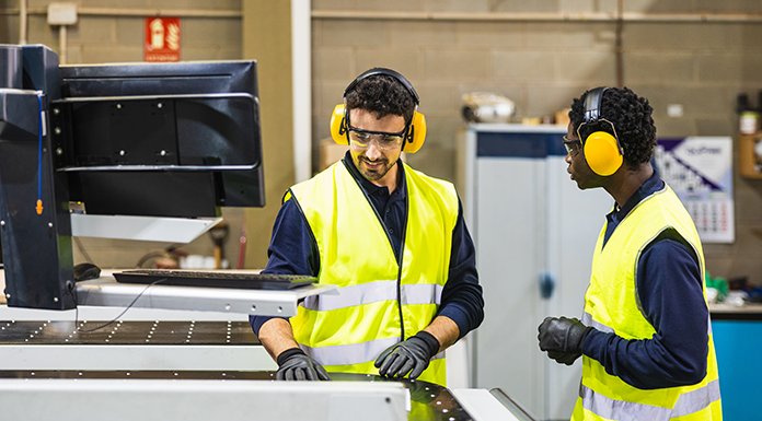 employee-working-ear-protection-safety-vest-696x385