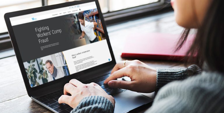 A person looking at a website on a laptop.