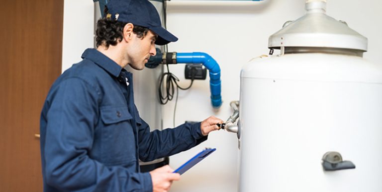 An employee working on a water heater.
