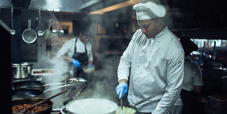 A chef cooking in a kitchen.