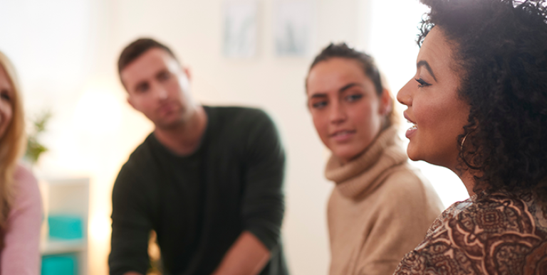 A group of employees talking to each other.