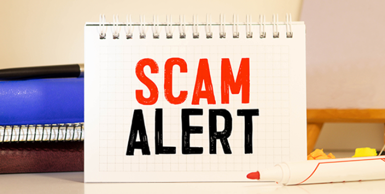 A sign that says Scam Alert.