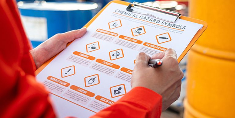 A person reviewing a hazard symbols worksheet.