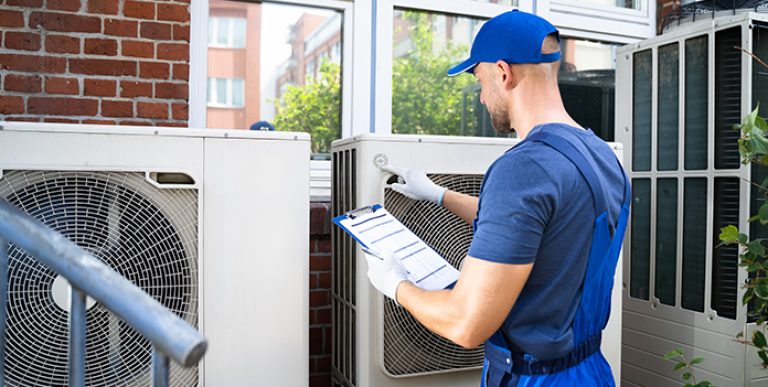Two Electricians Men Wearing Safety Jackets Checking Air Conditi