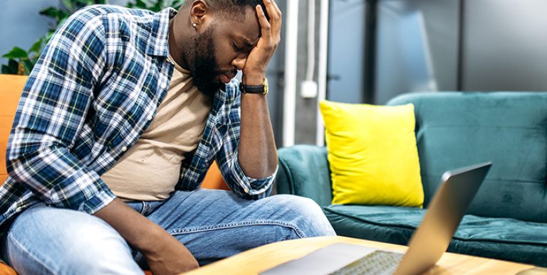 Tired African American Employee Or Student Is Sitting On The Sof