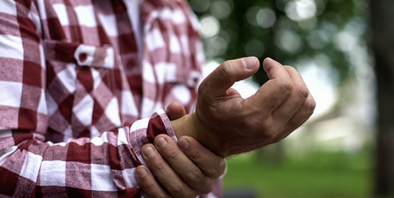 A worker holding his wrist.
