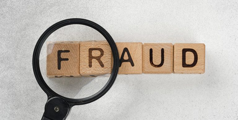 ICW Group's image of a magnifying glass looking at the word fraud.