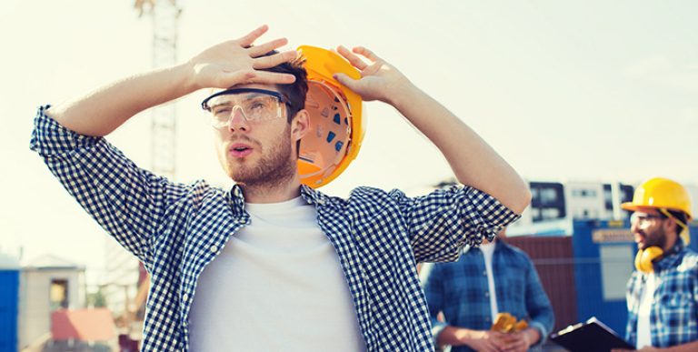 ICW Group's image of a construction worker wiping sweat from his brow.