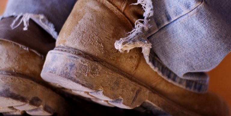 Work boots with mud on them.