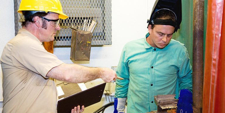 An inspector and an employee discussing a close call at the workplace.