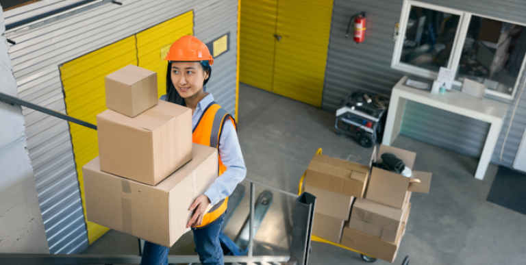 worker carrying materials upstairs 696x385
